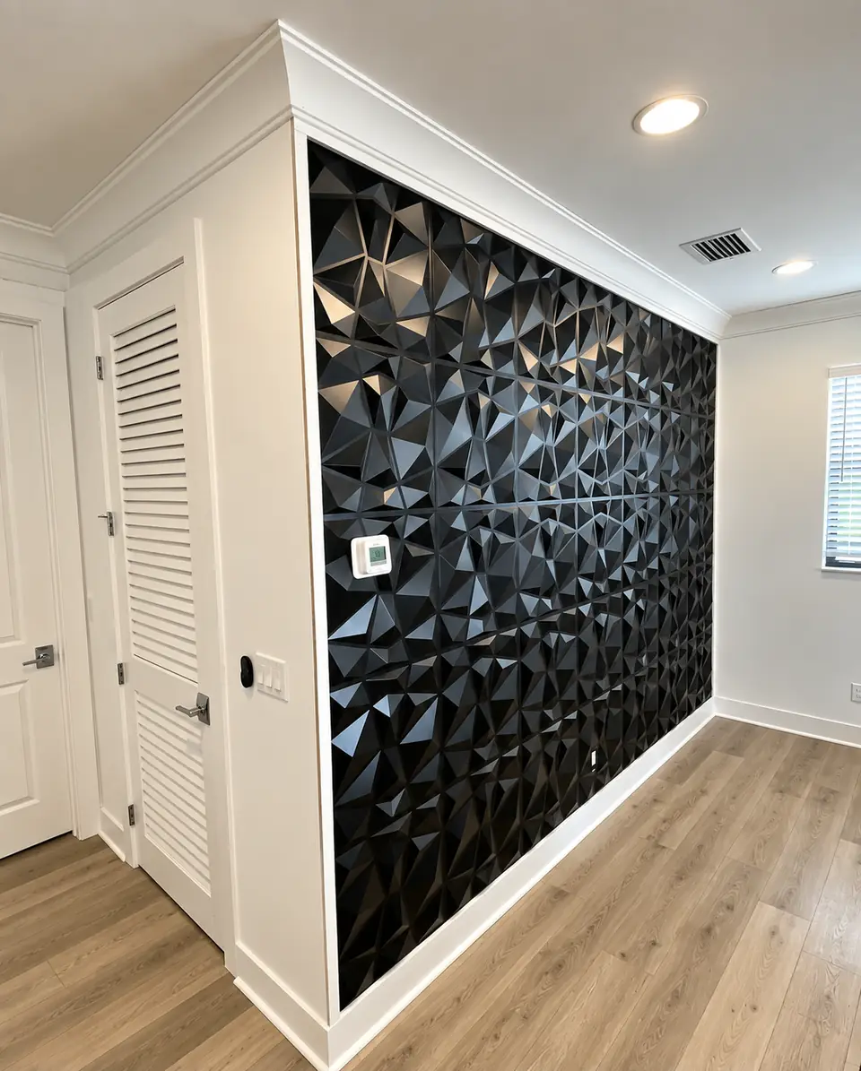 Black 3D textured accent wall framed with white trim in a hallway